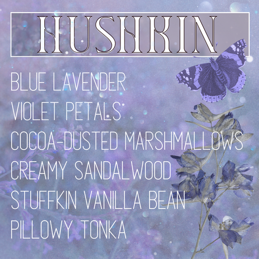 A fragrance product image for niche perfume 'Hushkin' by indie perfume house Mythpunk Olfactive with listed scent notes including blue lavender, violet petals, cocoa-dusted marshmallows, creamy sandalwood, stuffkin vanilla bean, and pillowy tonka, set on a background image of lavender below a gauzy, glittering overlay with collage cut-outs of a purple butterfly and dried, pressed lavender-colored flowers on top.